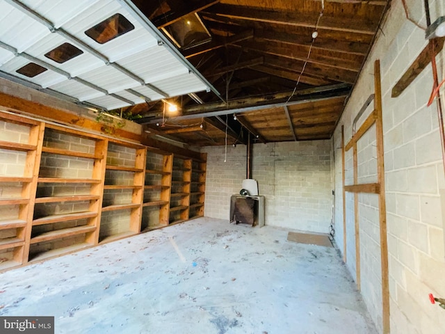 interior space with a wood stove and concrete floors