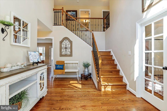 interior space with a high ceiling and wood-type flooring