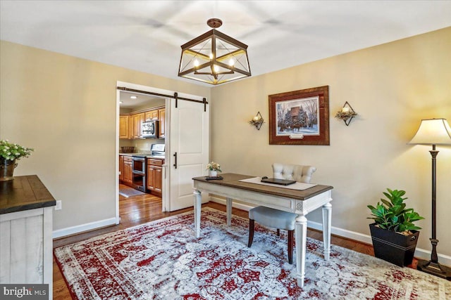 home office featuring a barn door, dark hardwood / wood-style floors, and a notable chandelier