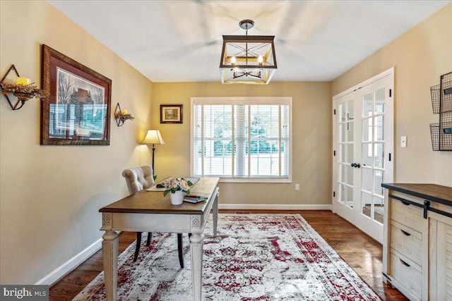 home office featuring wood-type flooring, an inviting chandelier, and french doors