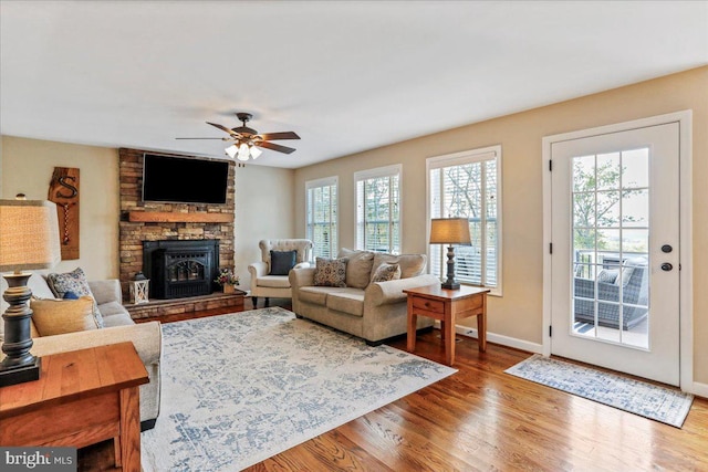 living room featuring hardwood / wood-style flooring, ceiling fan, and a healthy amount of sunlight