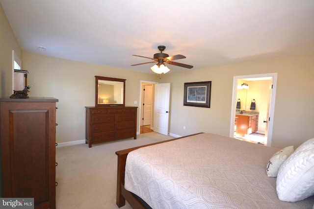 bedroom with light colored carpet, ceiling fan, and ensuite bathroom