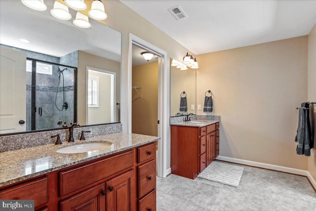 bathroom with vanity, an enclosed shower, and tile patterned flooring