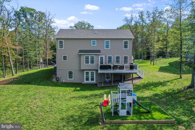 back of house featuring a deck, a playground, a yard, and french doors