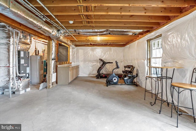 basement featuring electric water heater and heating unit