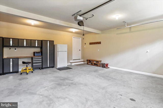 garage with a garage door opener and white fridge