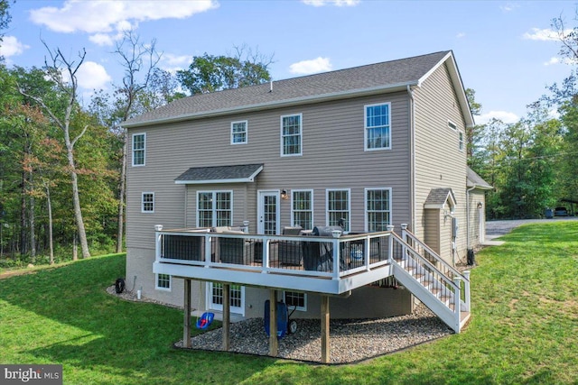 back of property with a lawn and a wooden deck