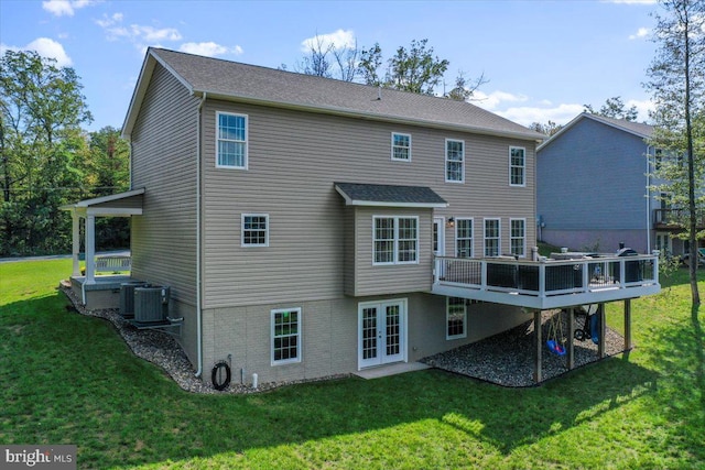 back of house featuring central AC unit, a lawn, french doors, and a wooden deck