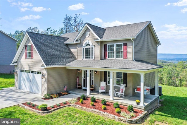 front facade featuring a garage, a front yard, and covered porch