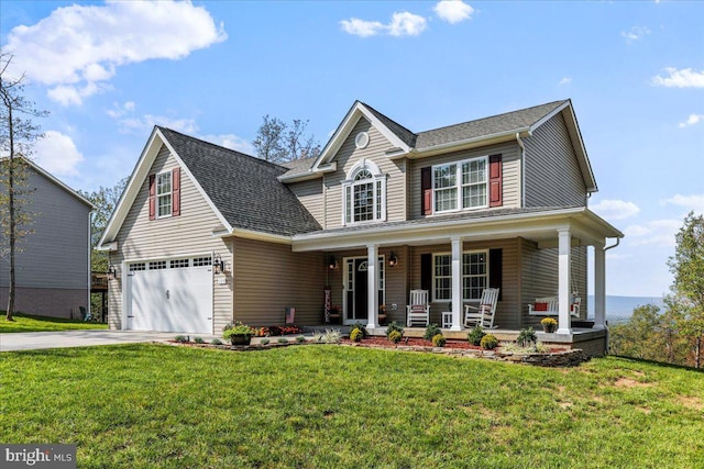 view of front of property with a front lawn, a garage, and covered porch