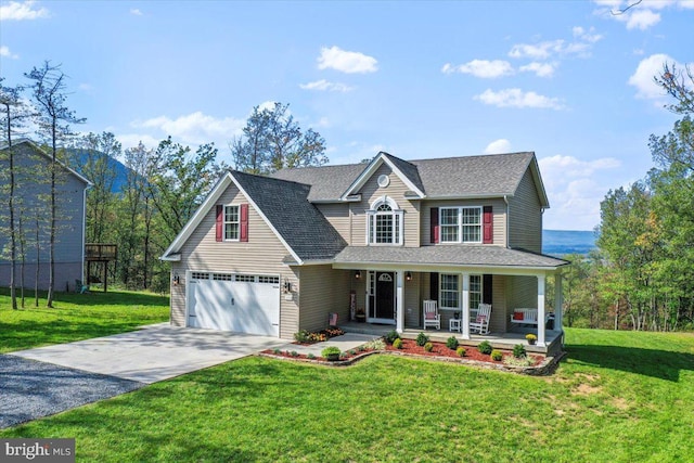 view of property featuring a front yard, a garage, and covered porch