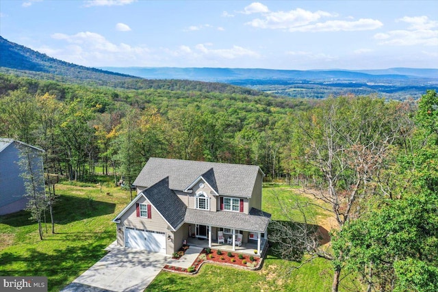 birds eye view of property featuring a mountain view