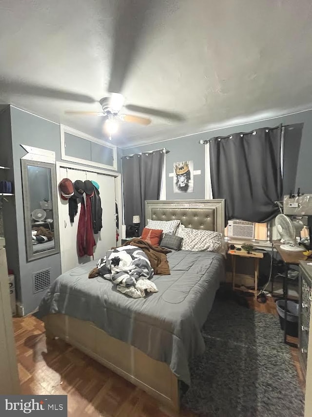 bedroom with hardwood / wood-style floors, ceiling fan, and a closet