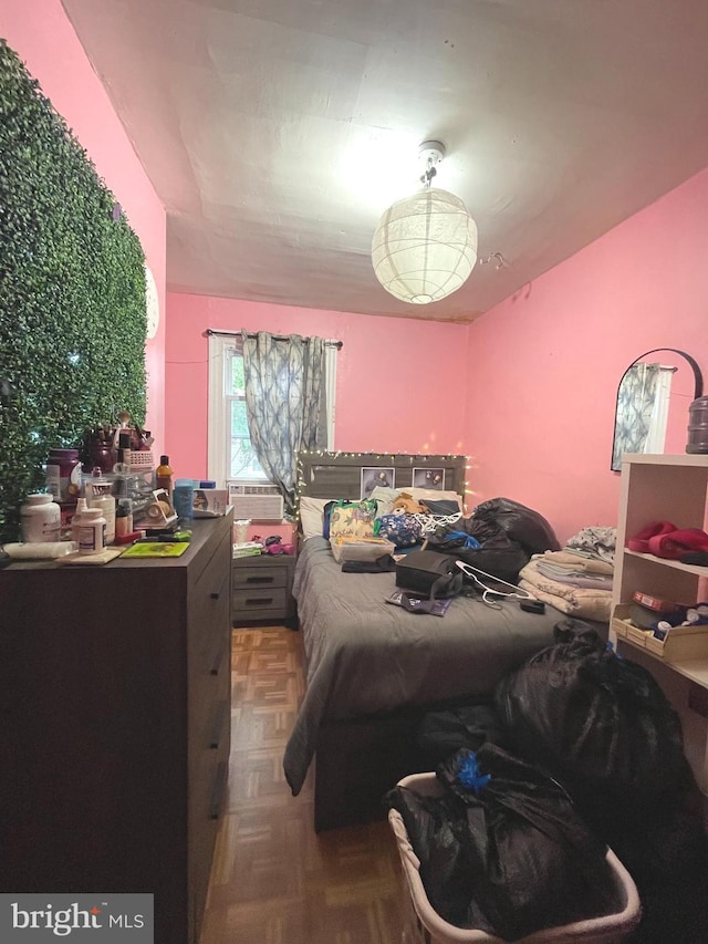 bedroom featuring parquet flooring and cooling unit