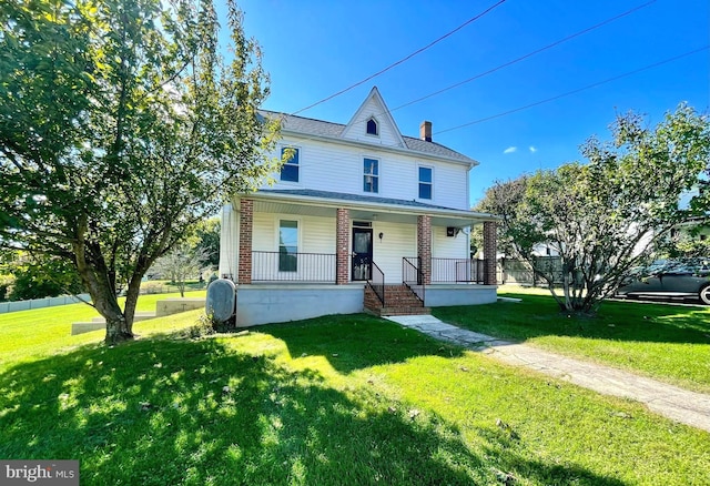 view of front of home with a porch and a front yard