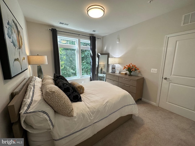 bedroom with light colored carpet