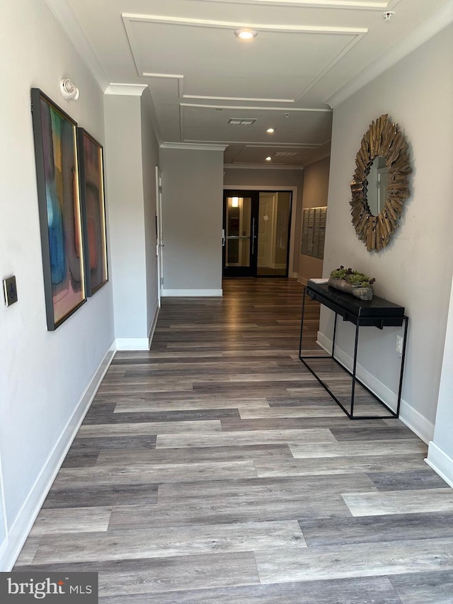 hallway with hardwood / wood-style floors and crown molding