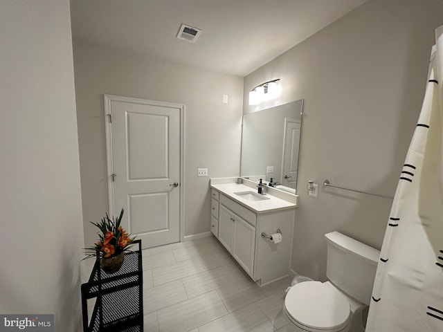 bathroom featuring vanity and toilet