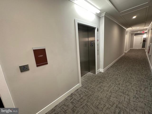 hall featuring crown molding, elevator, and dark carpet