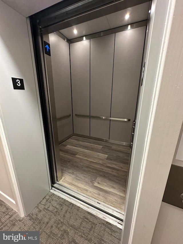 room details featuring hardwood / wood-style flooring and elevator