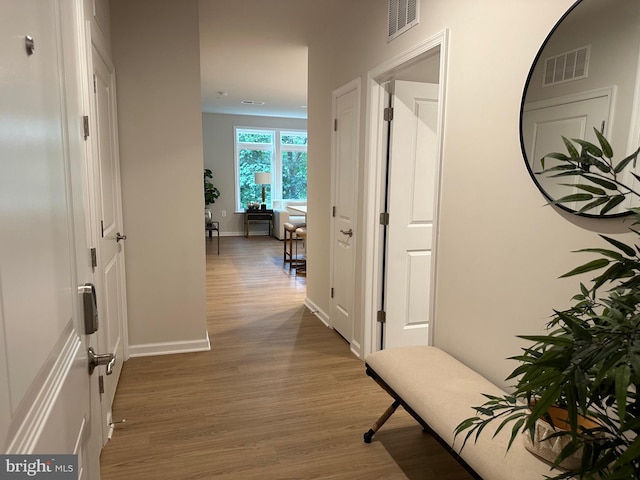 hallway with dark hardwood / wood-style flooring