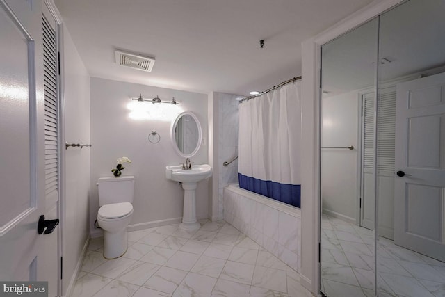 bathroom with shower / bath combination with curtain and toilet