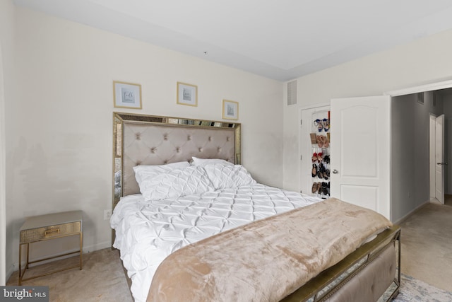 bedroom with light carpet and a closet