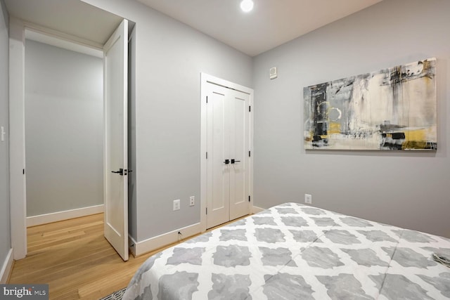 bedroom with a closet and hardwood / wood-style flooring