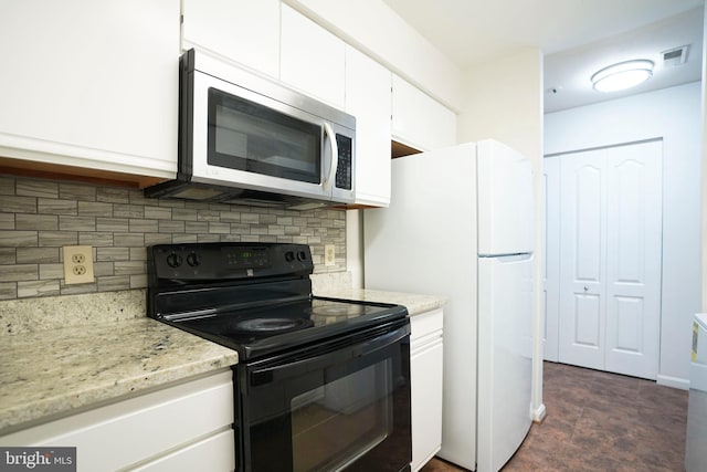 kitchen featuring light stone counters, white refrigerator, backsplash, white cabinetry, and electric range