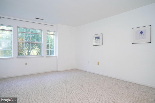 carpeted empty room with a healthy amount of sunlight