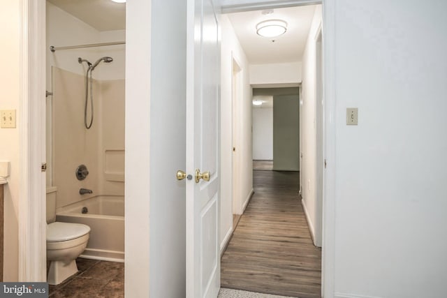 bathroom with shower / bathtub combination, hardwood / wood-style floors, and toilet