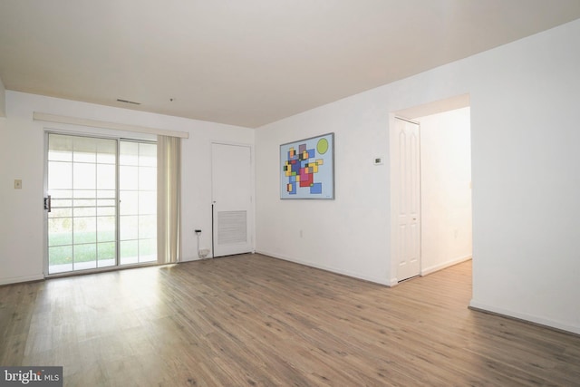 empty room with wood-type flooring