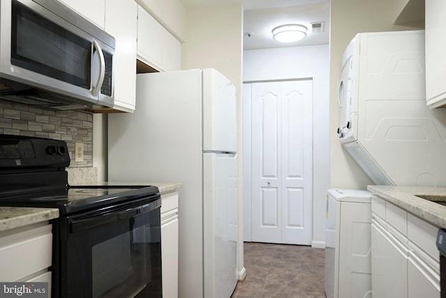 kitchen with black range with electric stovetop, backsplash, and white cabinetry