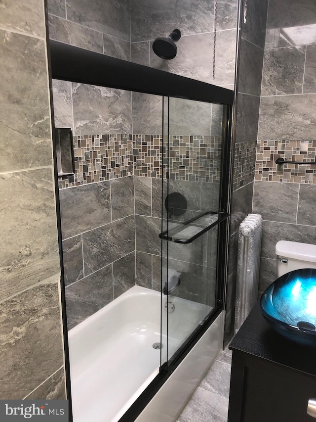 bathroom with shower / bath combination with glass door