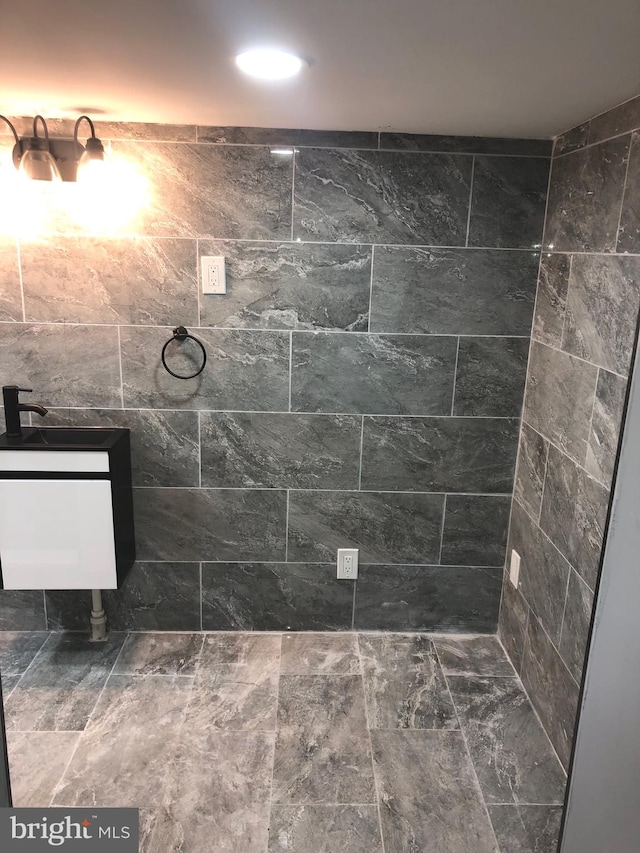 bathroom with tile walls