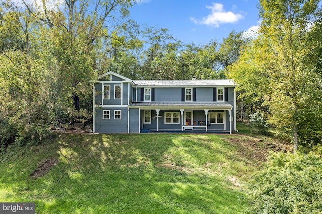 view of front of property with a porch and a front lawn