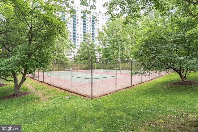 view of sport court featuring a lawn