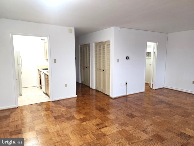 unfurnished room with parquet flooring