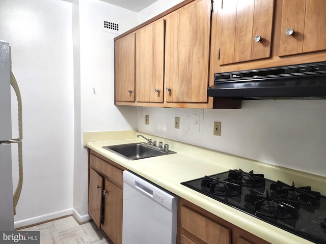 kitchen with white appliances, ventilation hood, and sink