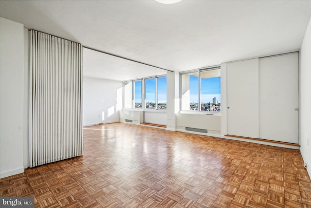 unfurnished room featuring parquet floors