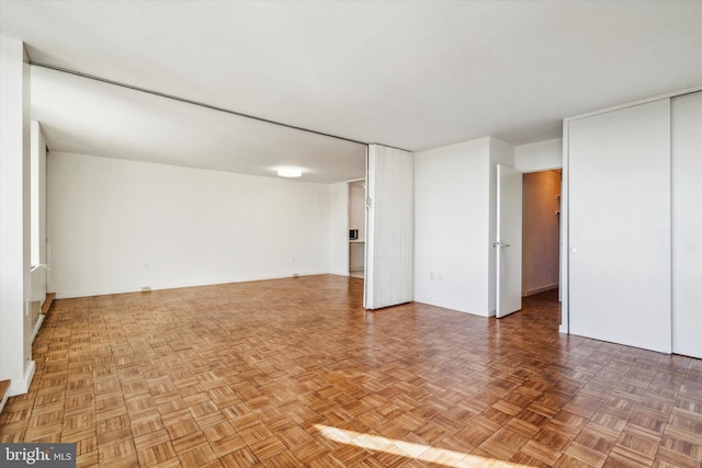 empty room featuring parquet flooring