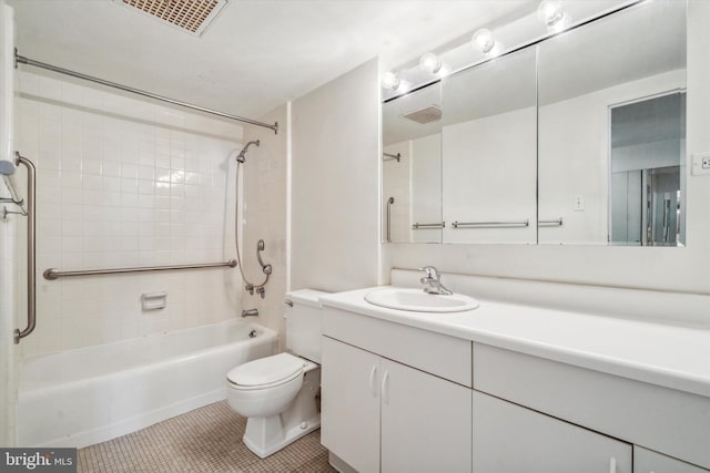 full bathroom featuring tile patterned flooring, vanity, tiled shower / bath combo, and toilet