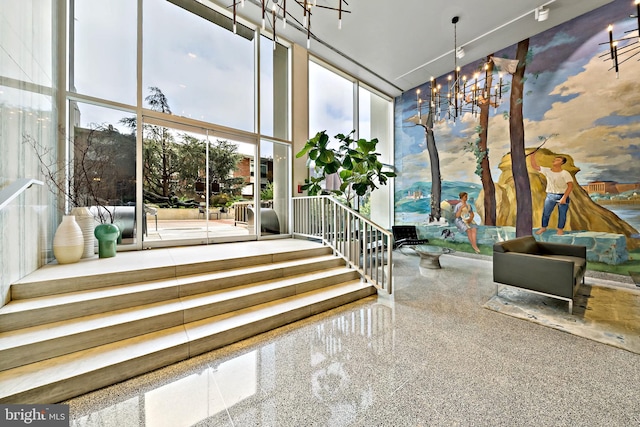 sunroom / solarium featuring a chandelier