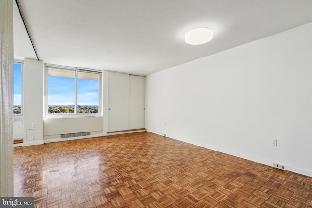 unfurnished room with parquet floors