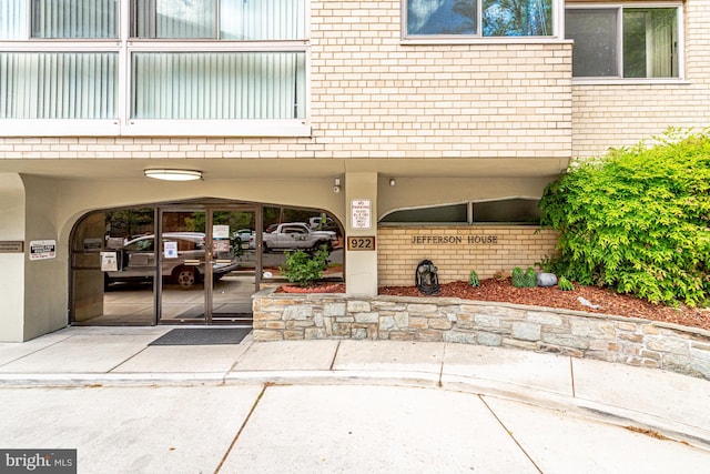 view of exterior entry featuring a carport