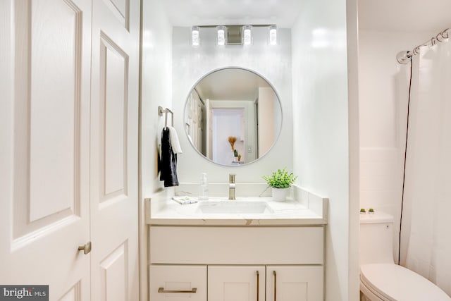 bathroom featuring vanity, toilet, and a shower with shower curtain