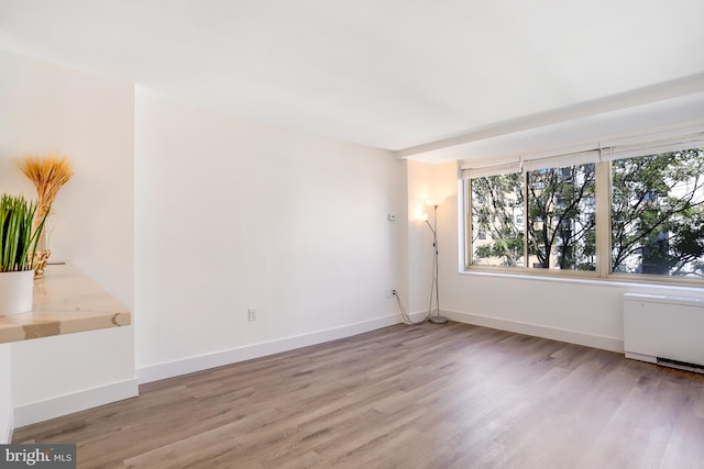 spare room featuring hardwood / wood-style floors