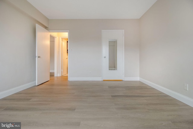 unfurnished room with light hardwood / wood-style flooring