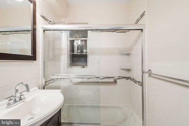 bathroom featuring vanity and tile walls