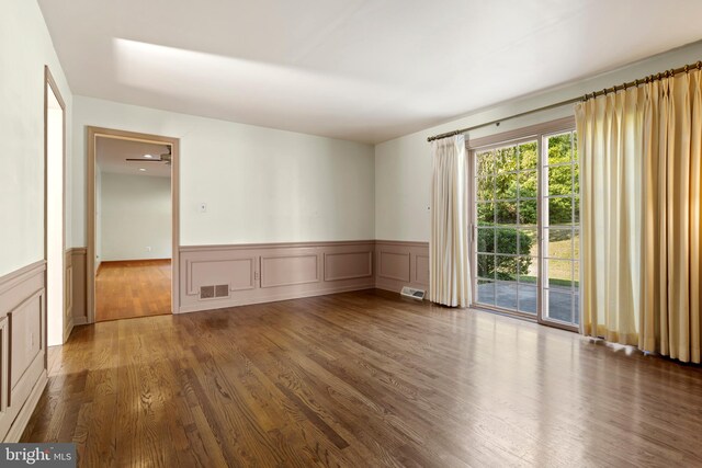 unfurnished room featuring dark wood-type flooring